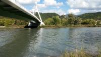 a bridge over a river next to a body of water at Maison La Minoterie in Volonne