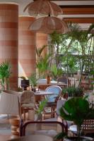 een restaurant met tafels en stoelen en potplanten bij Pakasai Resort in Ao Nang Beach