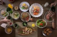 een houten tafel met borden met eten erop bij Pakasai Resort in Ao Nang Beach