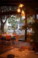 a restaurant with tables and chairs and a large window at פינה בראש מלונאות ותיירות in Rosh Pinna