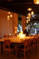 a long wooden table with candles and wine glasses at פינה בראש מלונאות ותיירות in Rosh Pinna