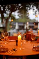 a table with wine glasses and a candle on it at פינה בראש מלונאות ותיירות in Rosh Pinna
