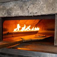 a pizza is being cooked in an oven at Alder Resort Hotel in Kemer