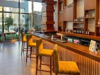 a bar in a restaurant with chairs and a counter at Canal Central Hotel Business Bay in Dubai