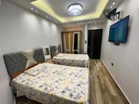 Postel nebo postele na pokoji v ubytování Grand Oasis Rooms