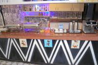 a kitchen with a counter with a counter top with a counter at Fuego Hotel in Kampala