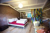 a bedroom with a bed and a brick wall at Shabby Home 28 in Jiufen