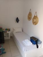 a room with a white bed with towels and baskets at Theofanis Studios in Agia Anna Naxos