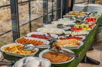 una linea a buffet con piatti di cibo su un tavolo di Belenus Cave House a Ürgüp