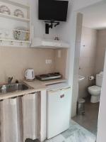 a small kitchen with a sink and a toilet at Theofanis Studios in Agia Anna Naxos