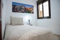 A bed or beds in a room at Apartamento Atenea centro con garaje gratuito