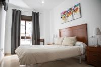 A bed or beds in a room at Apartamento Atenea centro con garaje gratuito