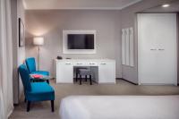 a hotel room with a bed and a desk and a tv at Hotel Florenc in Prague