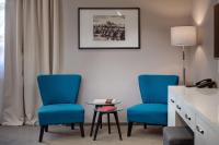 two blue chairs and a table in a room at Hotel Florenc in Prague