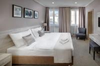 a bedroom with a white bed and a blue chair at Hotel Florenc in Prague