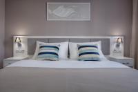 a bedroom with a white bed with two blue and white pillows at Hotel Florenc in Prague