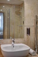 a bathroom with a white sink and a shower at Hotel Florenc in Prague