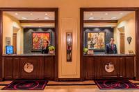 a lobby with two counters with paintings on them at The Raphael Hotel, Autograph Collection in Kansas City