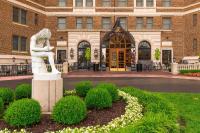 a statue of a woman in front of a building at The Raphael Hotel, Autograph Collection in Kansas City