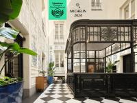 a black iron gate in a building with a checkered floor at Only YOU Boutique Hotel Madrid in Madrid