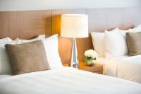 a hotel room with two beds and a lamp at Renaissance Santo Domingo Jaragua Hotel & Casino in Santo Domingo