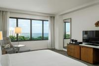 a hotel room with a bed and a large window at Renaissance Santo Domingo Jaragua Hotel & Casino in Santo Domingo