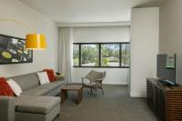 a living room with a couch and a tv at Renaissance Santo Domingo Jaragua Hotel & Casino in Santo Domingo