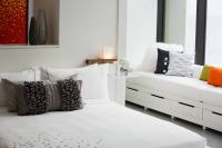 a bedroom with a white bed with pillows and a couch at Renaissance Santo Domingo Jaragua Hotel & Casino in Santo Domingo