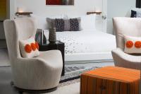 a bedroom with a bed and two chairs and a table at Renaissance Santo Domingo Jaragua Hotel & Casino in Santo Domingo