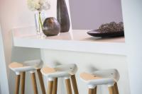 a row of white stools sitting under a shelf at Renaissance Santo Domingo Jaragua Hotel & Casino in Santo Domingo