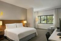 a hotel room with a large bed and a desk at Renaissance Santo Domingo Jaragua Hotel & Casino in Santo Domingo