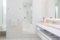 a white bathroom with a shower and a sink at Renaissance Santo Domingo Jaragua Hotel & Casino in Santo Domingo