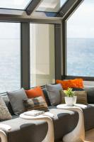 a couch with pillows and a table in front of a window at Renaissance Santo Domingo Jaragua Hotel & Casino in Santo Domingo