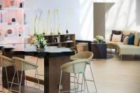 a living room with a table and chairs at Renaissance Santo Domingo Jaragua Hotel & Casino in Santo Domingo