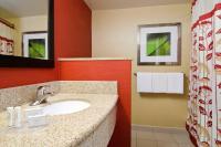 a bathroom with a sink and a red wall at Courtyard by Marriott Birmingham Downtown at UAB in Birmingham