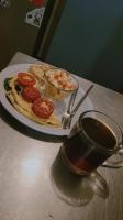 a plate of food with tomatoes and a cup of coffee at Casa Makoi in Tamanique