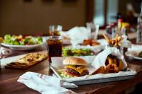 una mesa con un sándwich y algo de comida. en Holiday Inn & Suites Columbia NE - Ft Jackson Area by IHG, en Columbia