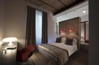 A bed or beds in a room at Atypical Rooms