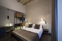 A bed or beds in a room at Atypical Rooms