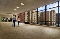 a man and a woman walking in a building hallway at Courtyard by Marriott Birmingham Downtown at UAB in Birmingham