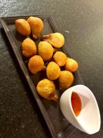 a tray with food and a bowl of dipping sauce at Manoir Des Douets Fleuris in Cancale