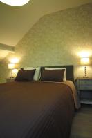 a bedroom with a large bed with two lamps at Bed &amp; Breakfast De Kleine Magnolia in Tessenderlo