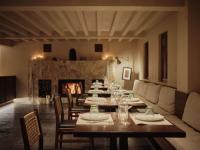 un comedor con una mesa larga y una chimenea en 大理空岛半山海景民宿, en Dali