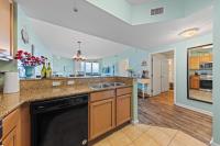 eine große Küche mit Spüle und Geschirrspüler in der Unterkunft 5 Star Resort 11th Fl Stunning Sunrise 2BR 2BA King Suite,Pools ,Shuttle or Walk to Beach in Destin