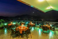 a restaurant with tables and chairs on a balcony at night at Hotel Manang - Thamel, Kathmandu in Kathmandu