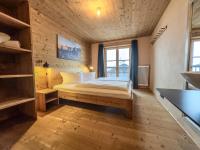 A bed or beds in a room at alpen select lodge Kleinwalsertal