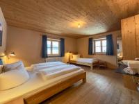 A bed or beds in a room at alpen select lodge Kleinwalsertal