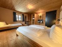A bed or beds in a room at alpen select lodge Kleinwalsertal