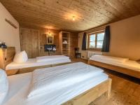 A bed or beds in a room at alpen select lodge Kleinwalsertal
