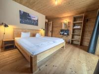 A bed or beds in a room at alpen select lodge Kleinwalsertal